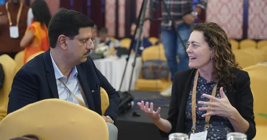 Elaine Gowdy speaking with Dr. Nipun Sharma, CEO of TeamLease Degree Apprenticeship at the Climate Workforce Summit