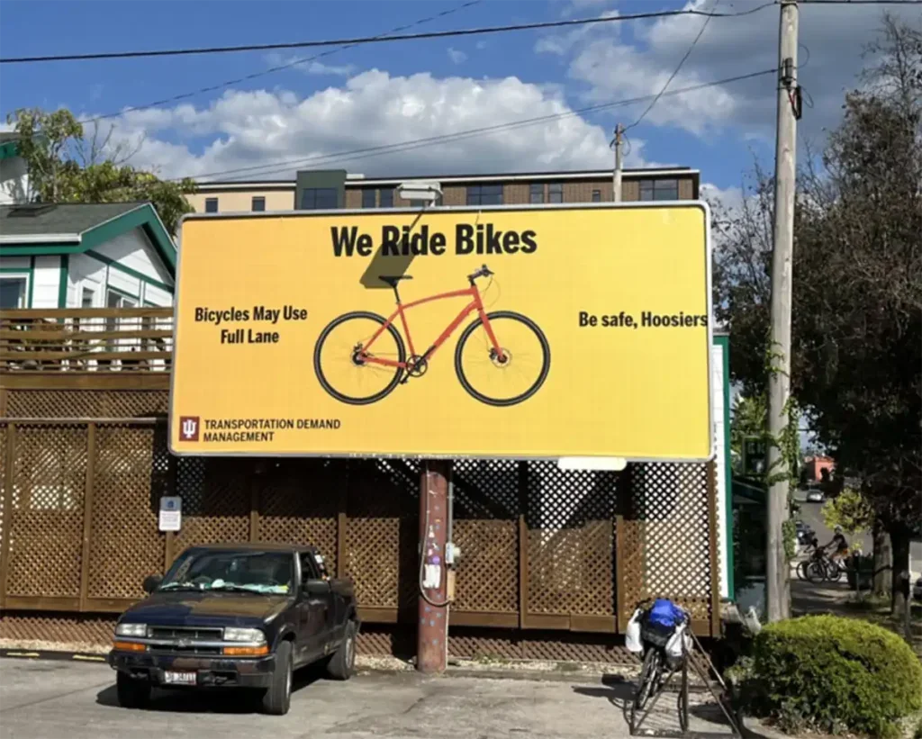 Image of sign that reads "We Ride Bikes"