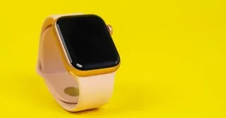 pple Watch Series 6 with pink rubber strap on yellow background